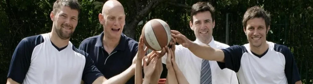 Andy and Danny with the local MP, hands together on a basketball at a school session
